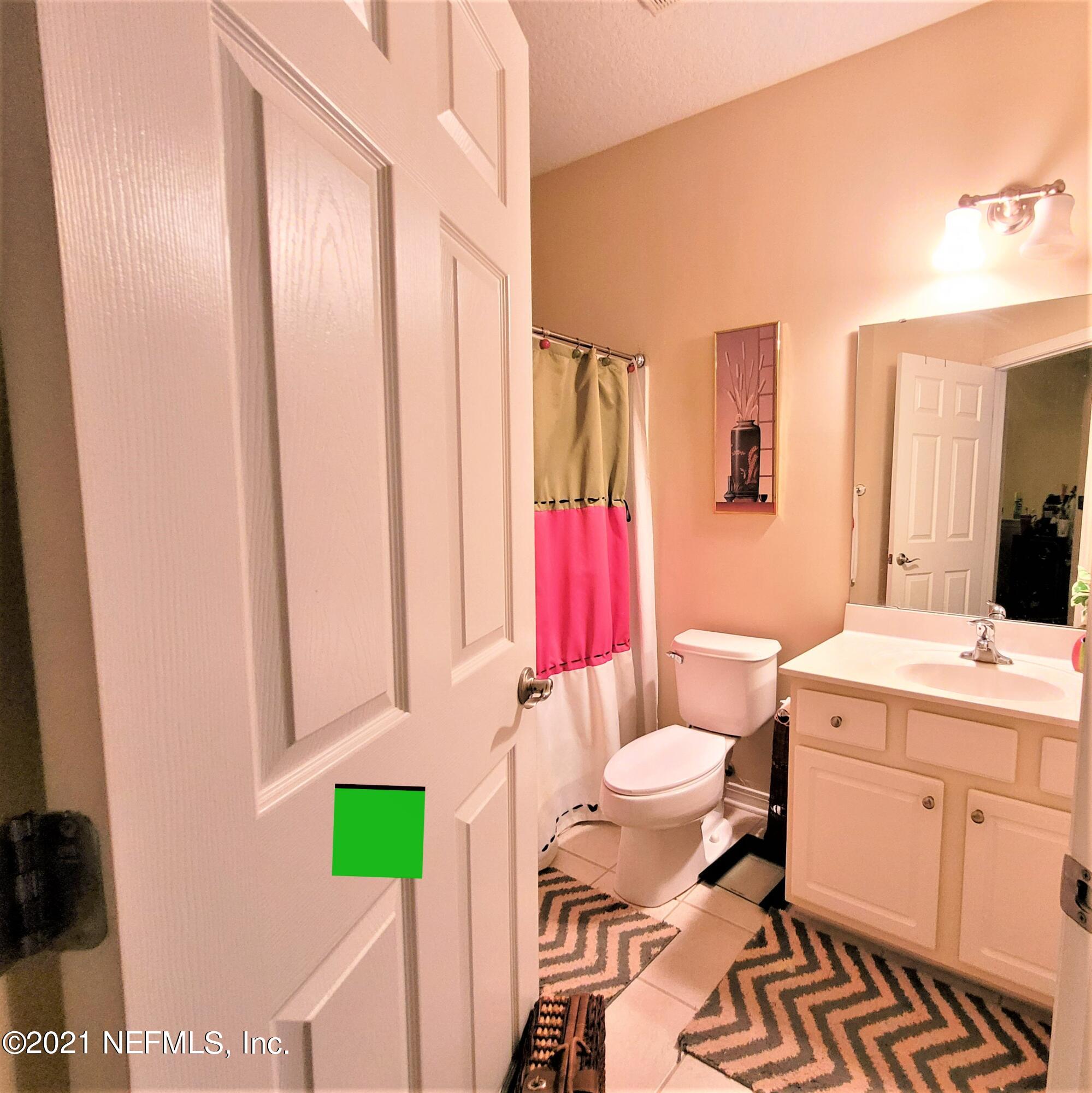 2190 Monument Road, Unit 104 Jacksonville, FL 32225 - Photo 21 of 27 a bathroom with a sink toilet and shower