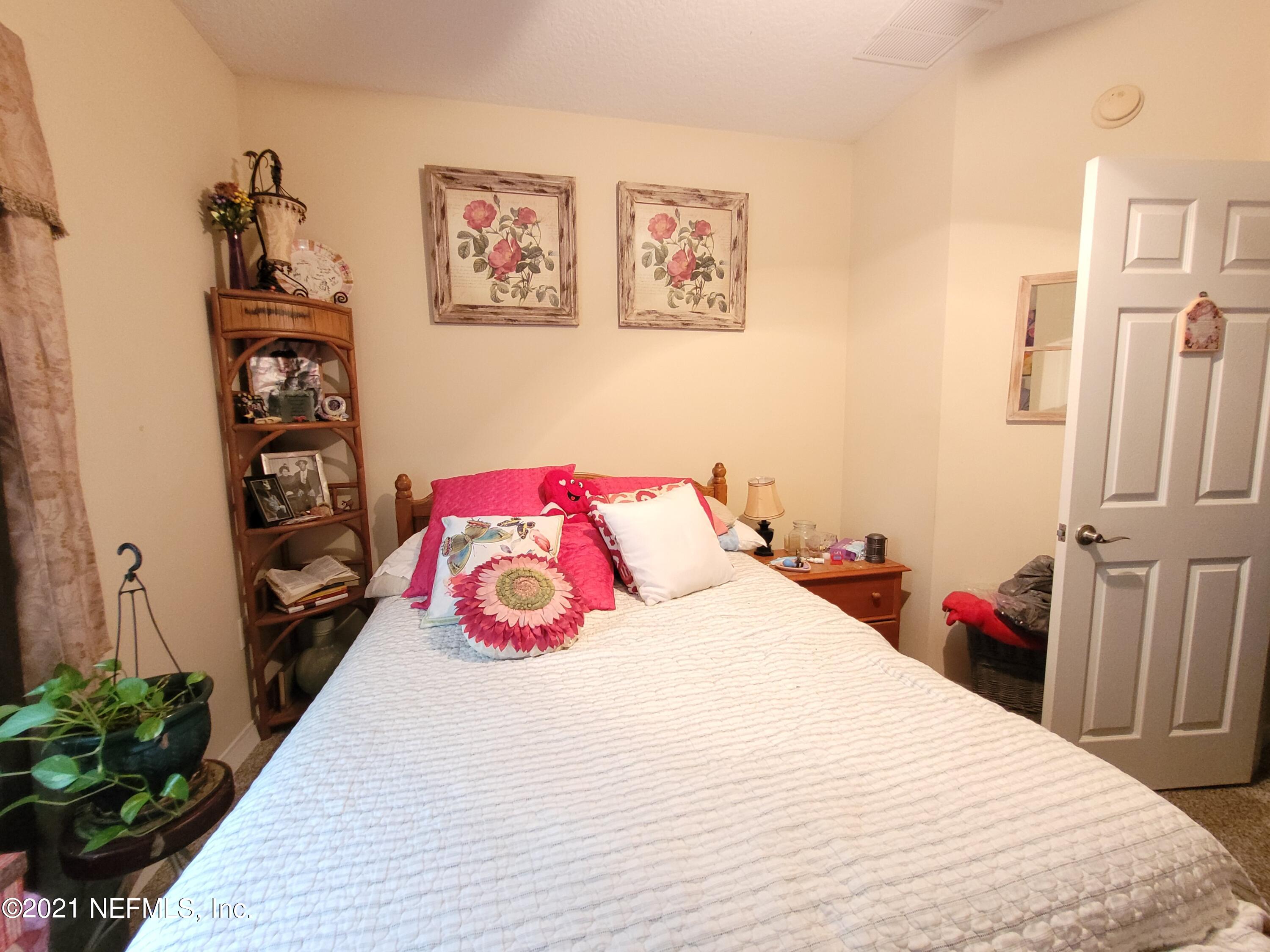 2190 Monument Road, Unit 104 Jacksonville, FL 32225 - Photo 22 of 27 a bedroom with a bed and a book shelf