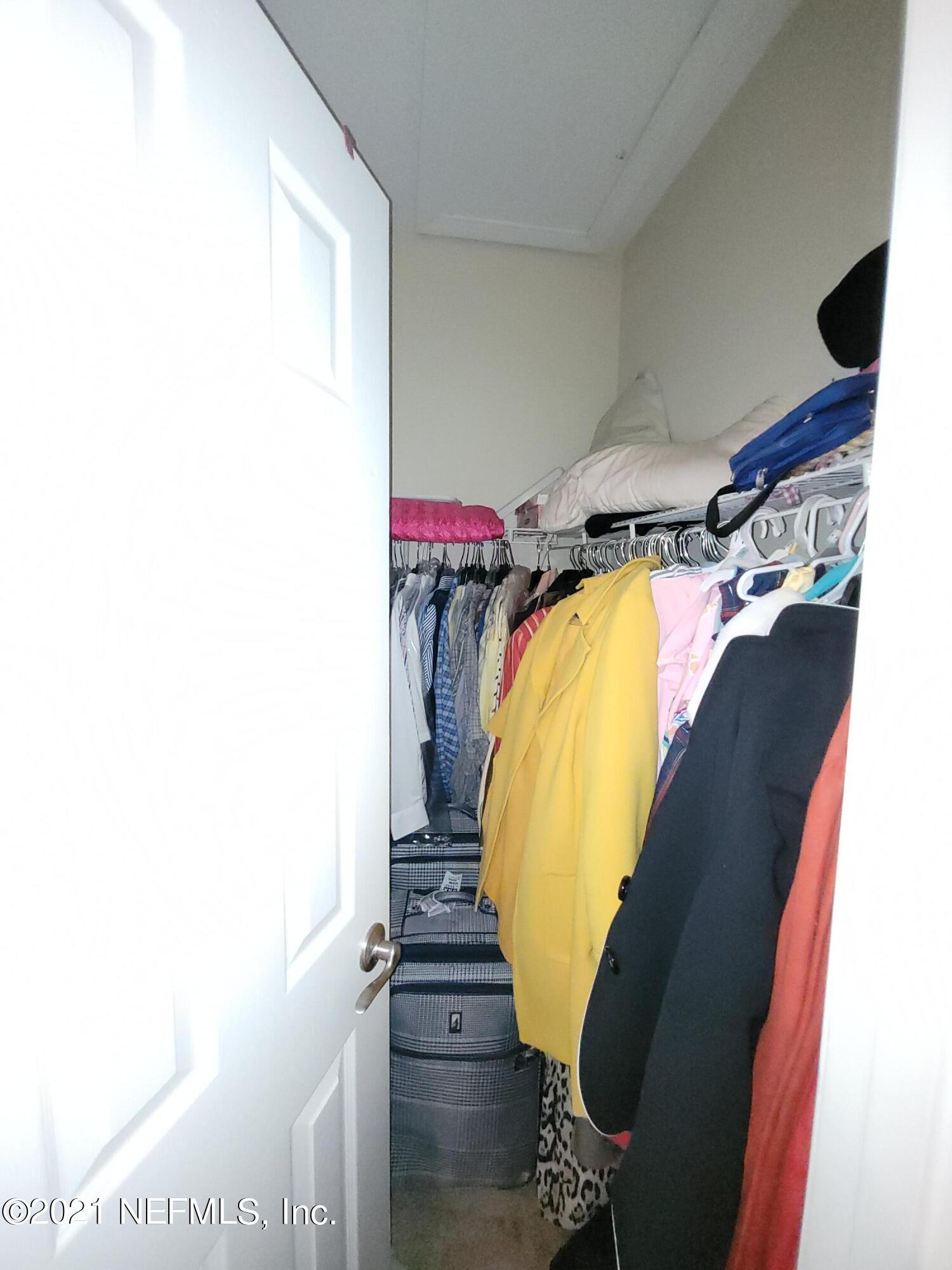 2190 Monument Road, Unit 104 Jacksonville, FL 32225 - Photo 23 of 27 a view of walk in closet with clothes and shoes