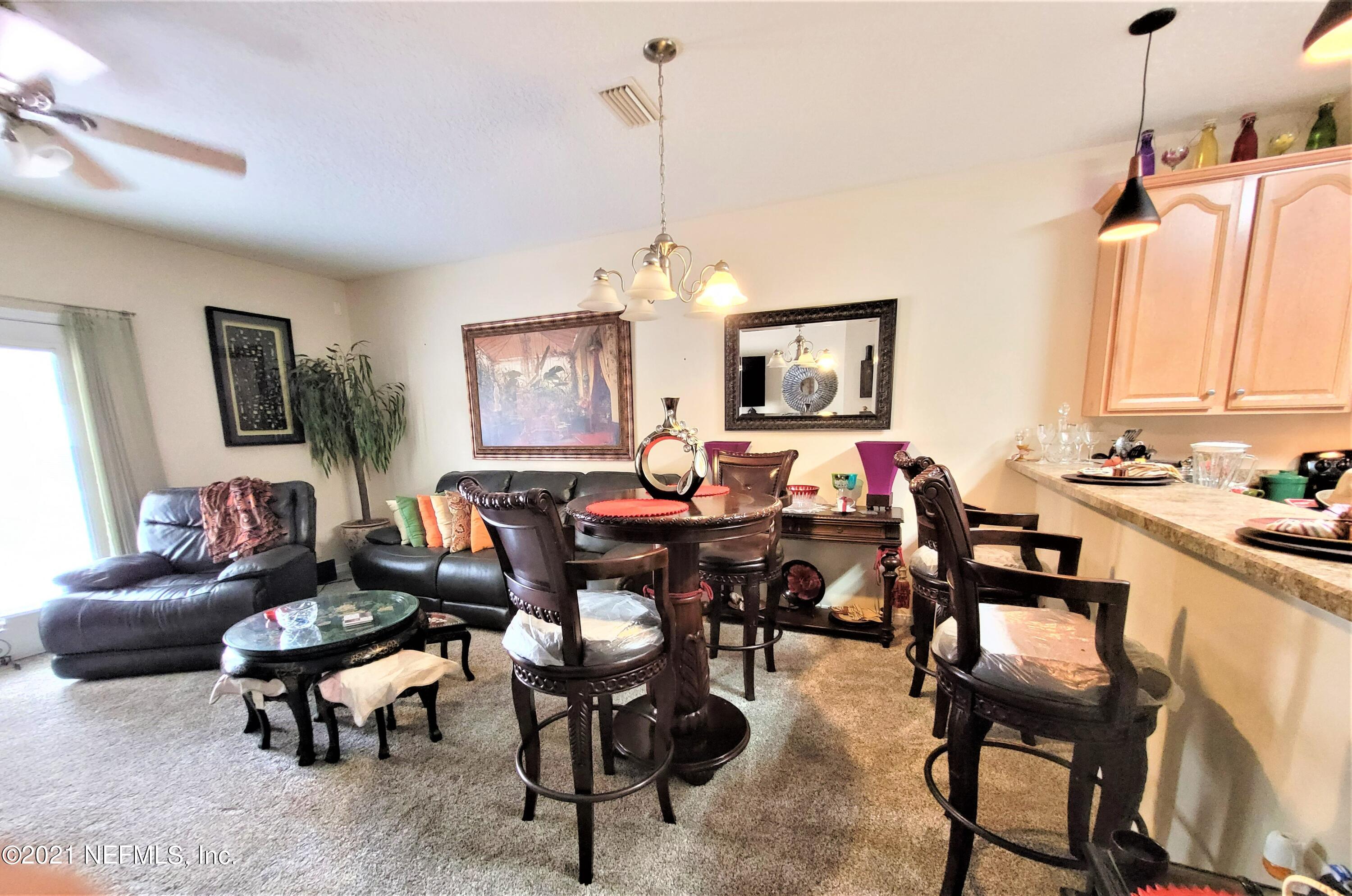 2190 Monument Road, Unit 104 Jacksonville, FL 32225 - Photo 9 of 27 a living room with furniture kitchen view and a window