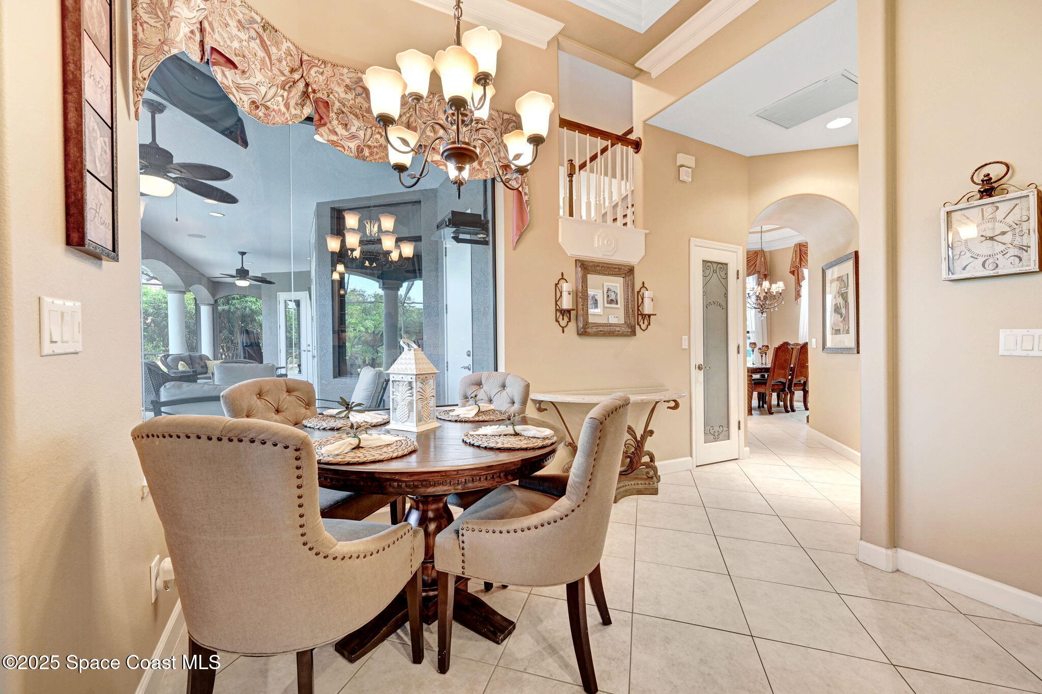 1418 Southpointe Court Melbourne, FL 32940 - Photo 20 of 52 a dining room with furniture a chandelier and window