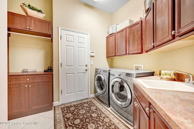 a kitchen with stainless steel appliances a dining table chairs and wooden floor