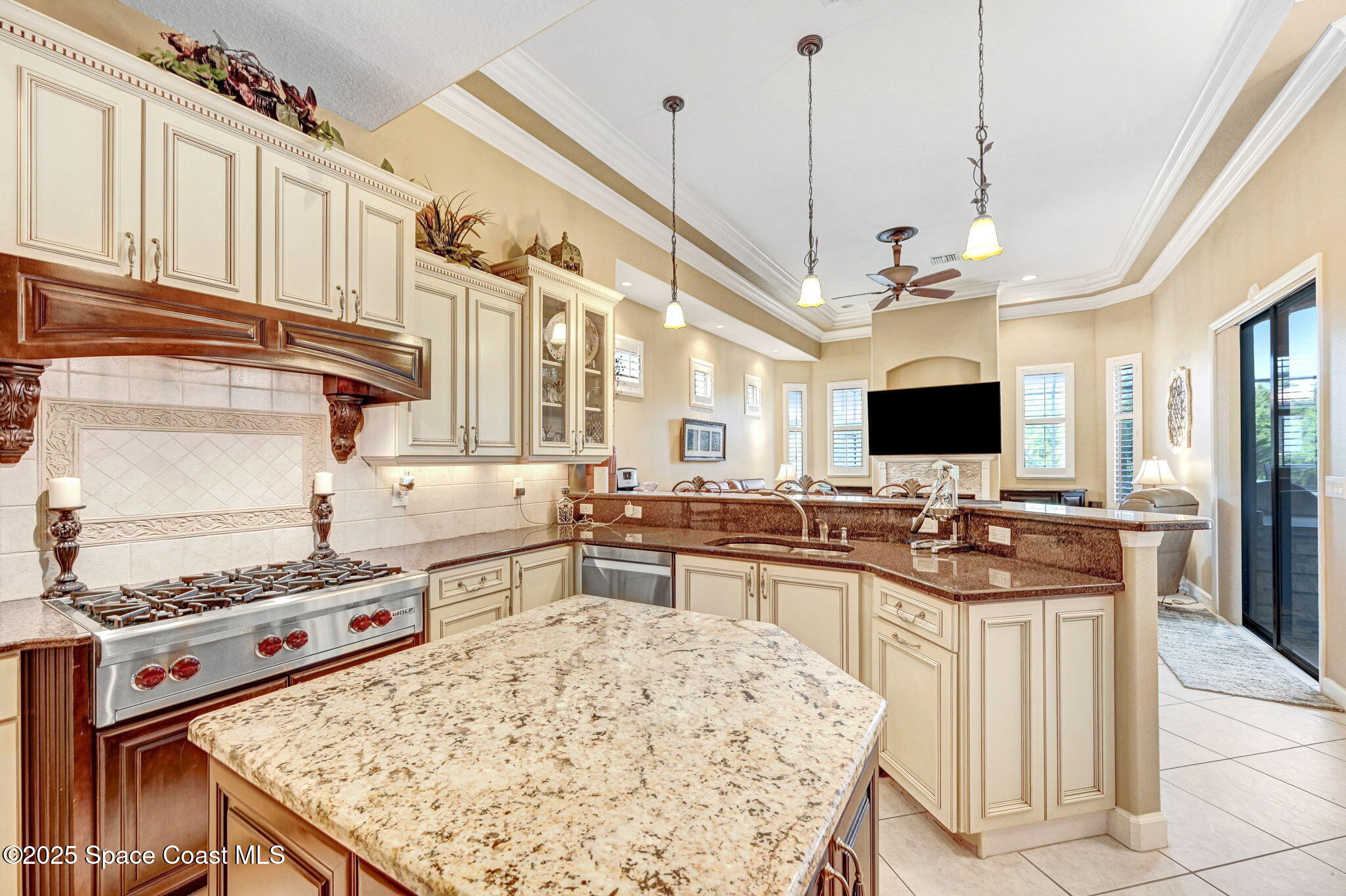 1418 Southpointe Court Melbourne, FL 32940 - Photo 23 of 52 a kitchen with stainless steel appliances granite countertop a stove oven and a view of living room
