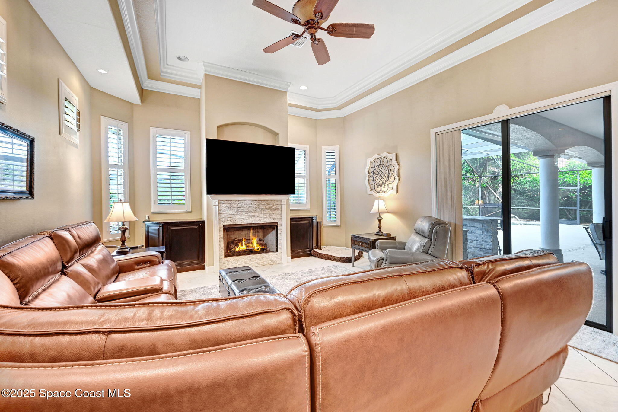 1418 Southpointe Court Melbourne, FL 32940 - Photo 26 of 52 a living room with fireplace furniture and a flat screen tv