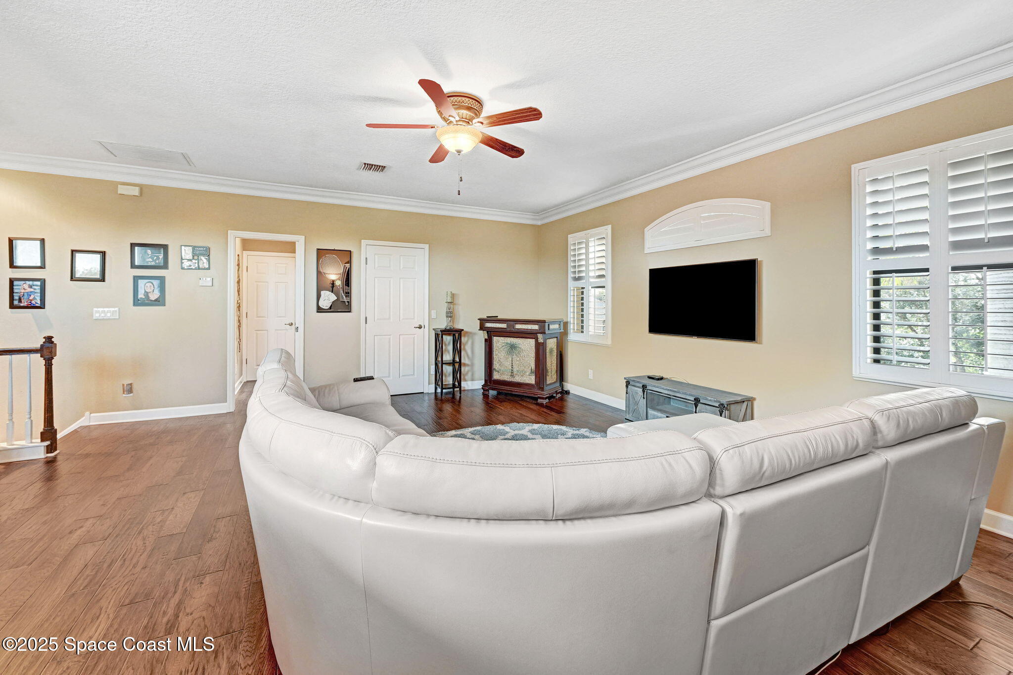 1418 Southpointe Court Melbourne, FL 32940 - Photo 44 of 52 a living room with furniture and a flat screen tv