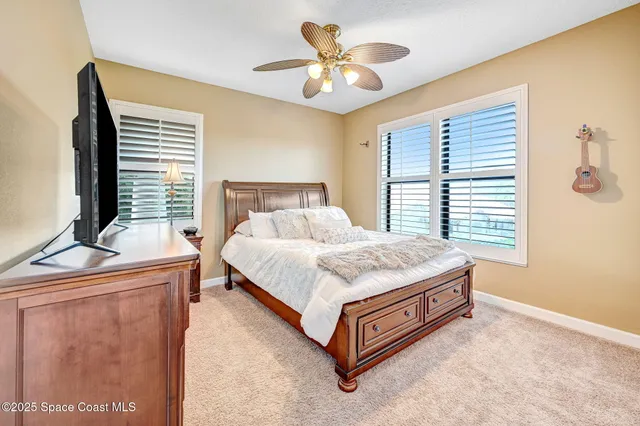 a spacious bedroom with a bed and a window