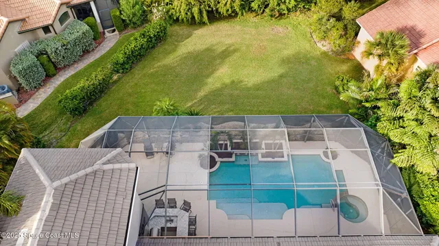 an aerial view of a house with swimming pool garden and patio