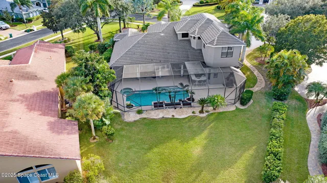 a aerial view of a house with a yard and potted plants