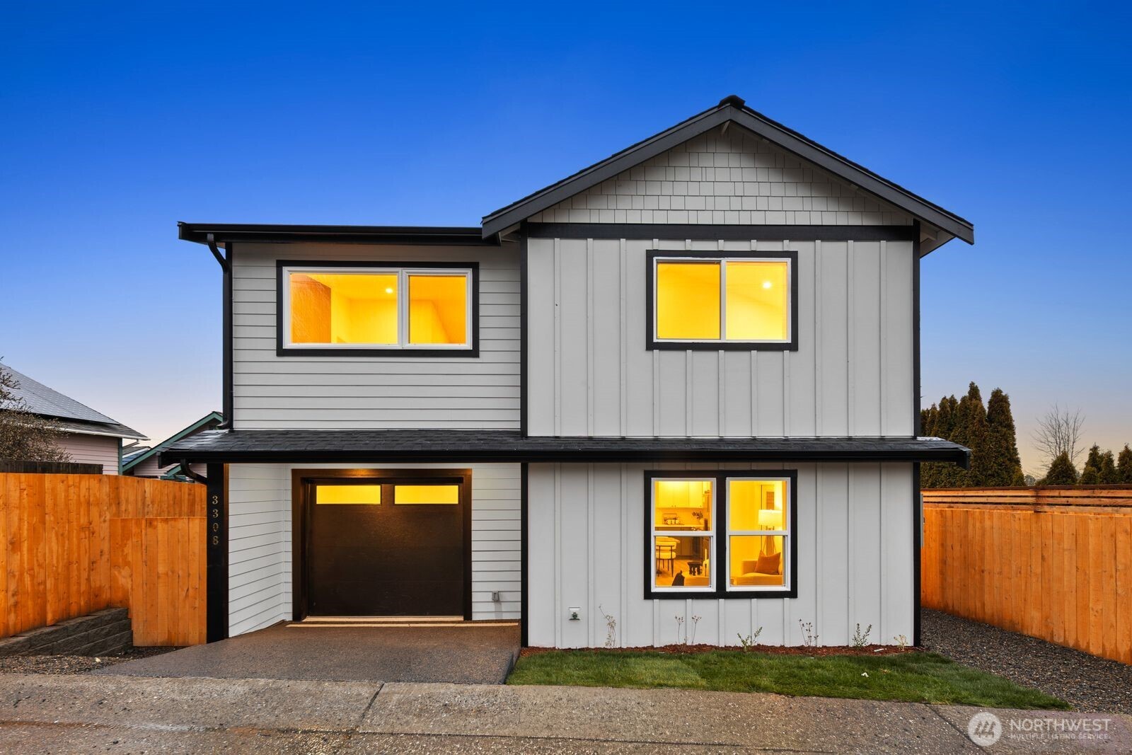 7555 32nd Avenue Southwest, Unit B Seattle, WA 98126 - Photo 1 of 1 a view of a house with many windows and yard