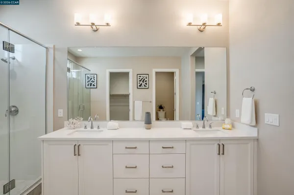 a bathroom with double sink and a mirror