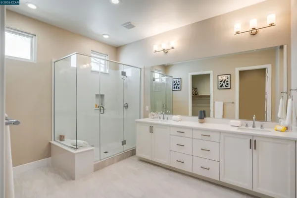 a spacious bathroom with a granite countertop sink mirror and bathtub