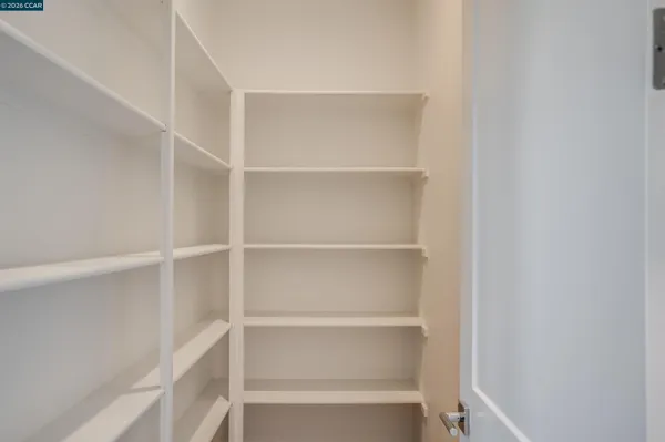 a view of walk in closet with empty racks