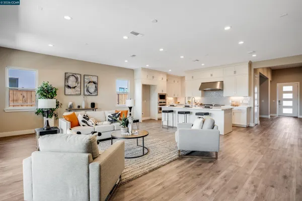 a living room with furniture and kitchen view