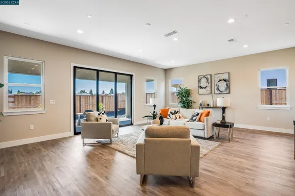 a living room with fireplace furniture and a wooden floor