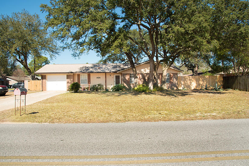 89 11th Avenue Shalimar, FL 32579 - Photo 2 of 9 a front view of a house with a yard