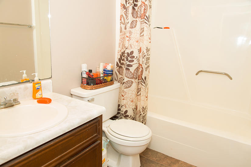 89 11th Avenue Shalimar, FL 32579 - Photo 6 of 9 a bathroom with a sink a toilet and shower curtain