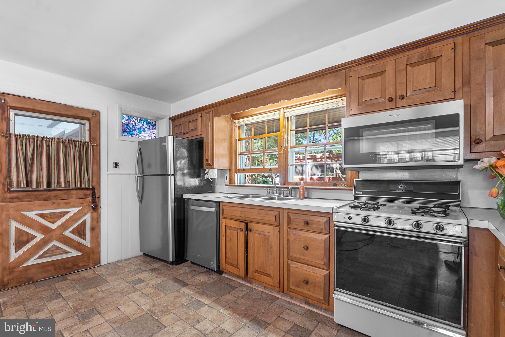 98 Spruce Lane Pine Hill, NJ 08021 - Photo 11 of 28 a kitchen with stainless steel appliances granite countertop a stove a refrigerator and a stove top oven