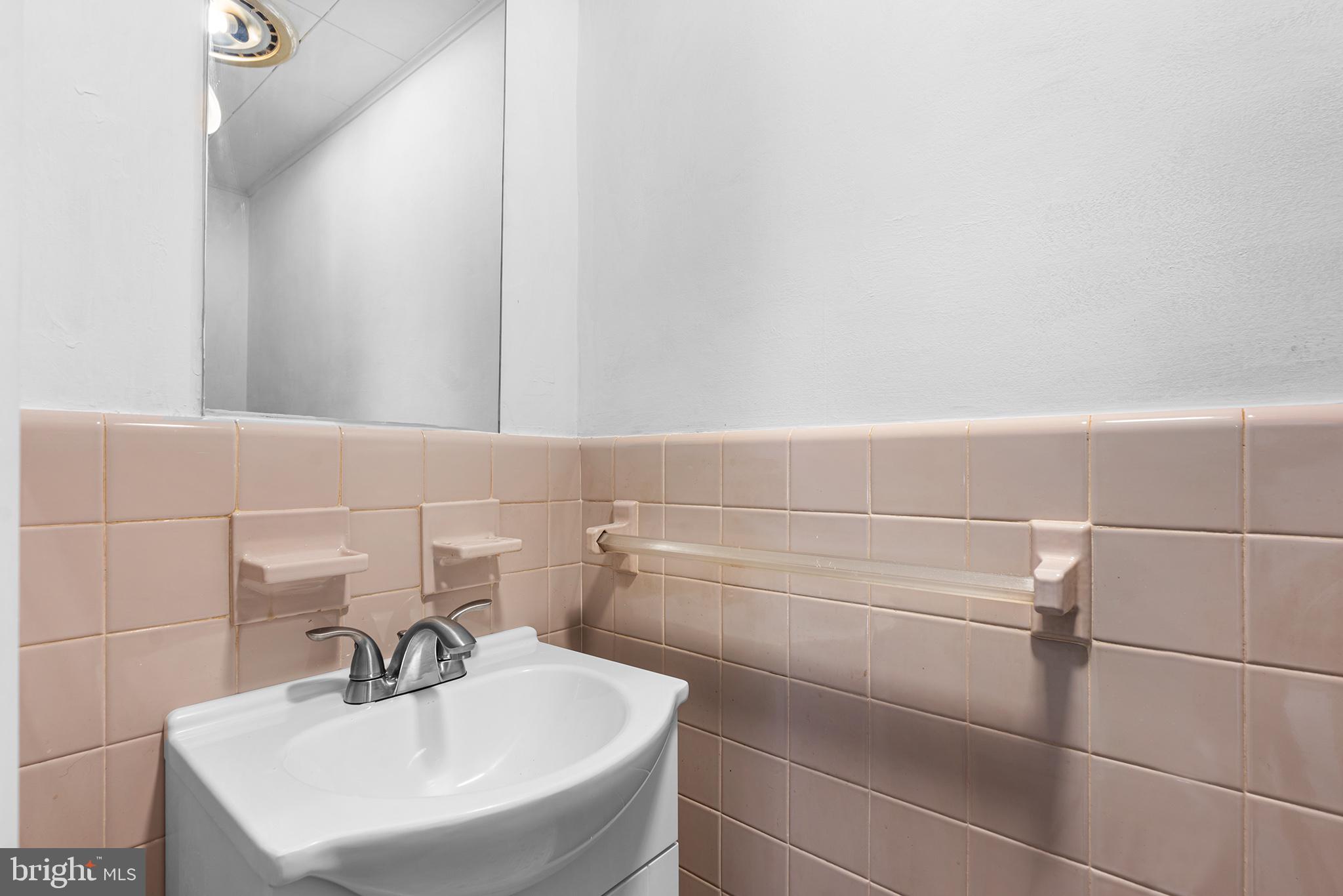 98 Spruce Lane Pine Hill, NJ 08021 - Photo 16 of 28 a bathroom with a sink and a mirror