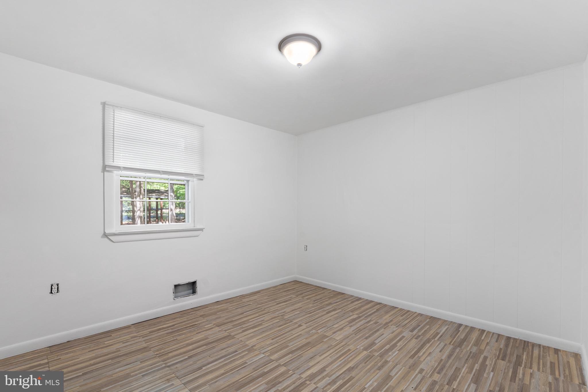 98 Spruce Lane Pine Hill, NJ 08021 - Photo 17 of 28 an empty room with wooden floor and windows