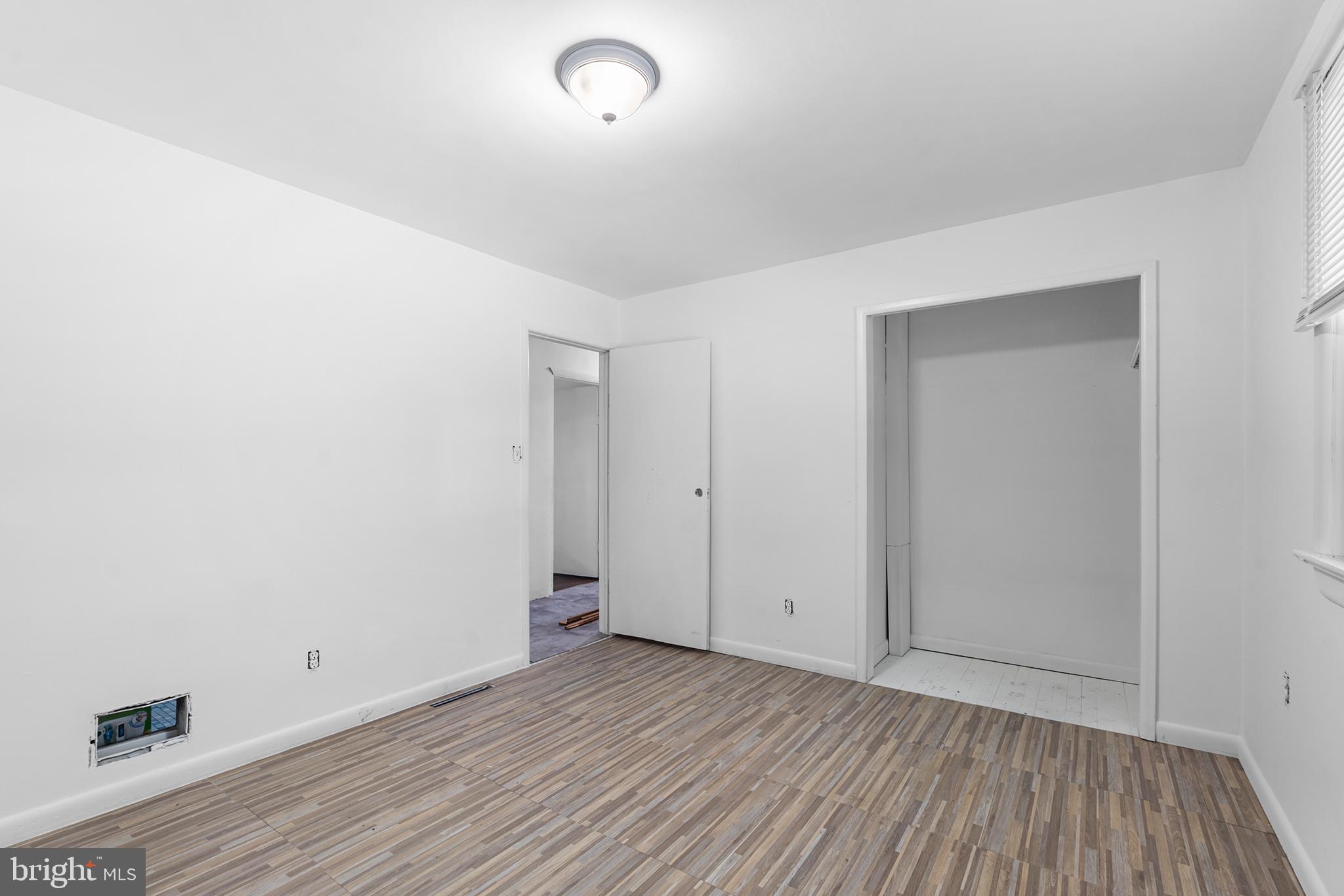 98 Spruce Lane Pine Hill, NJ 08021 - Photo 18 of 28 an empty room with wooden floor and windows