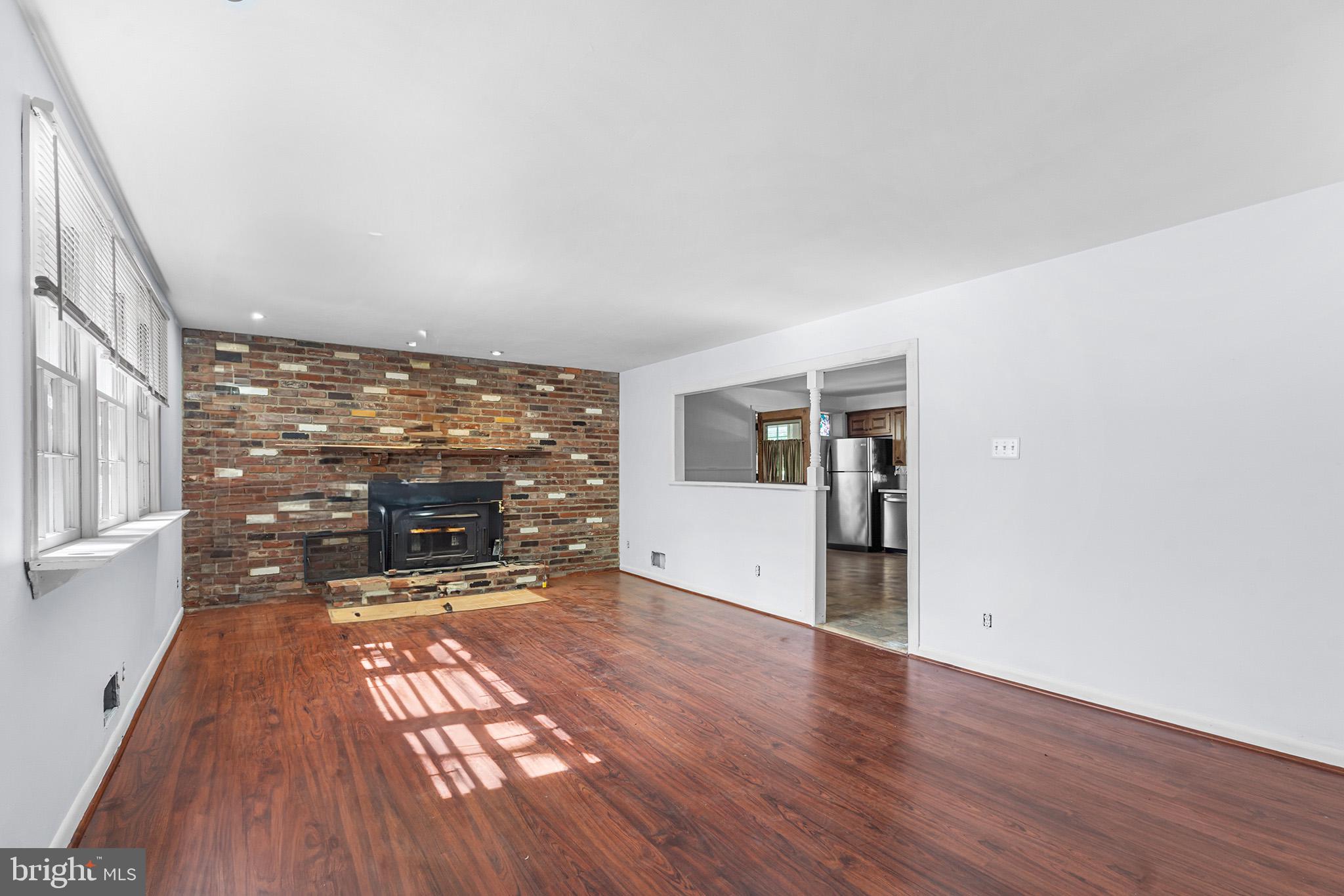 98 Spruce Lane Pine Hill, NJ 08021 - Photo 7 of 28 a view of an empty room with a fireplace and a window