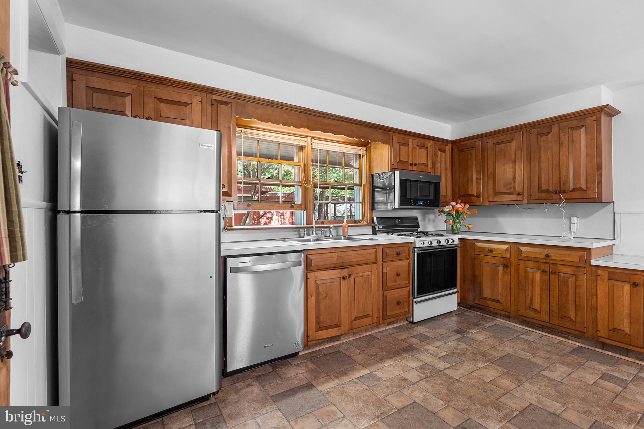 98 Spruce Lane Pine Hill, NJ 08021 - Photo 9 of 28 a kitchen with stainless steel appliances granite countertop a refrigerator stove top oven a sink and dishwasher
