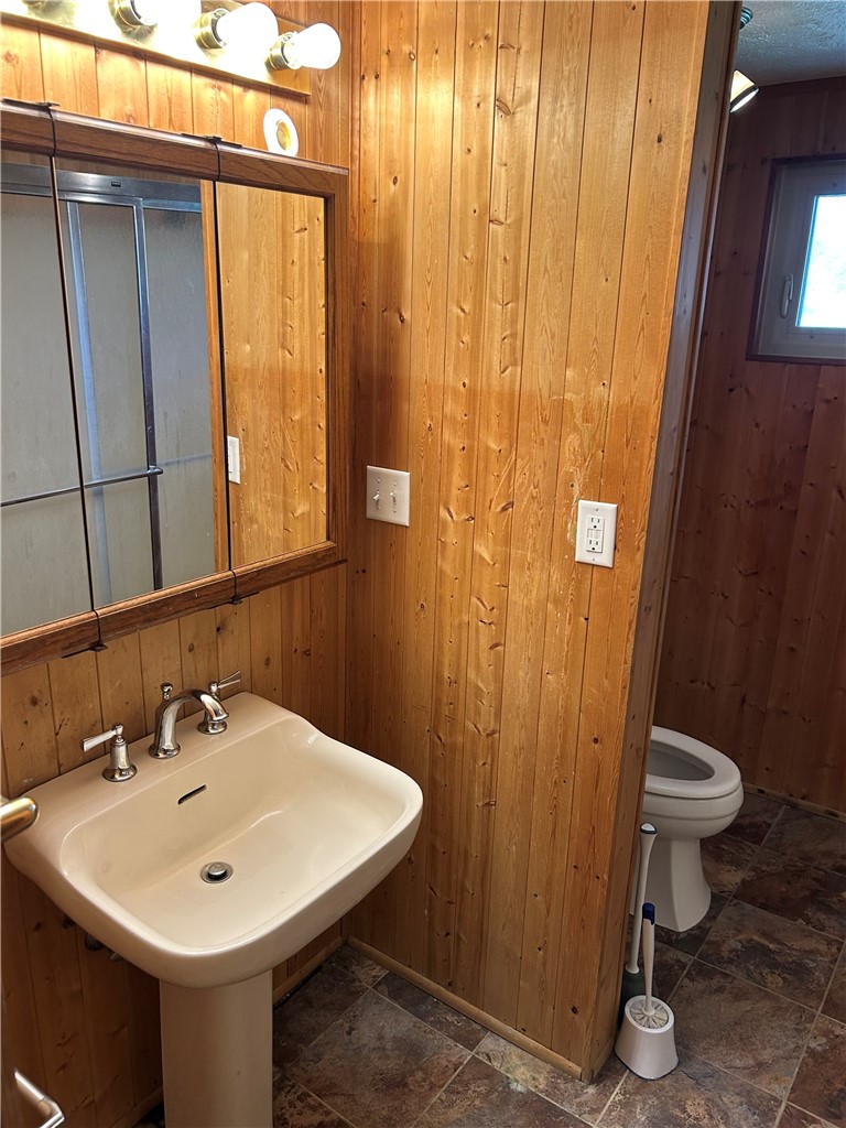 1358 Hanes Road Dayton, OH 45434 - Photo 13 of 21 This functional bathroom features natural wood paneling and a practical pedestal sink, perfect for everyday routines.