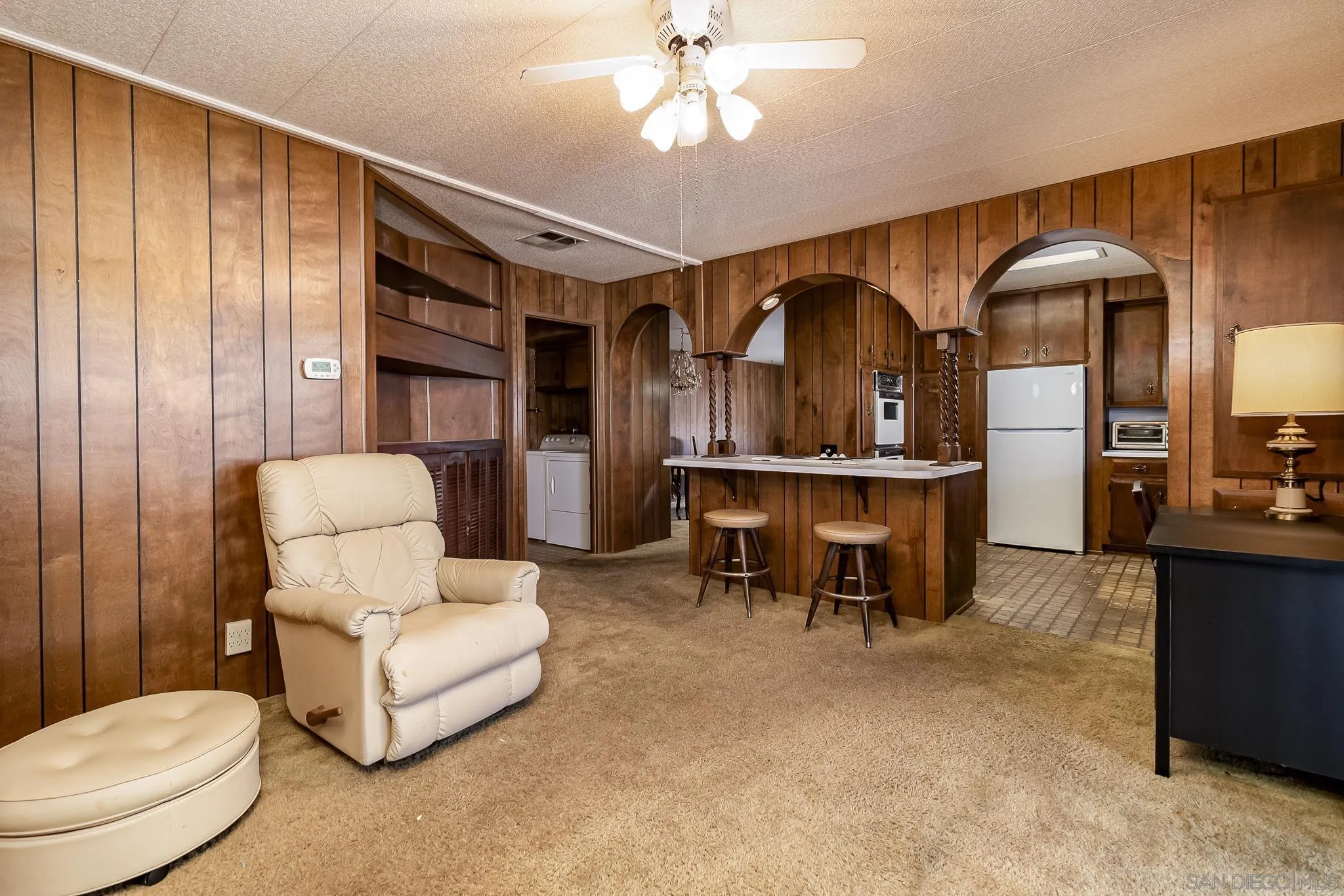 7467 Mission Gorge Road, Unit SPC 291 Santee, CA 92071 - Photo 16 of 40 a living room with furniture a table and kitchen view