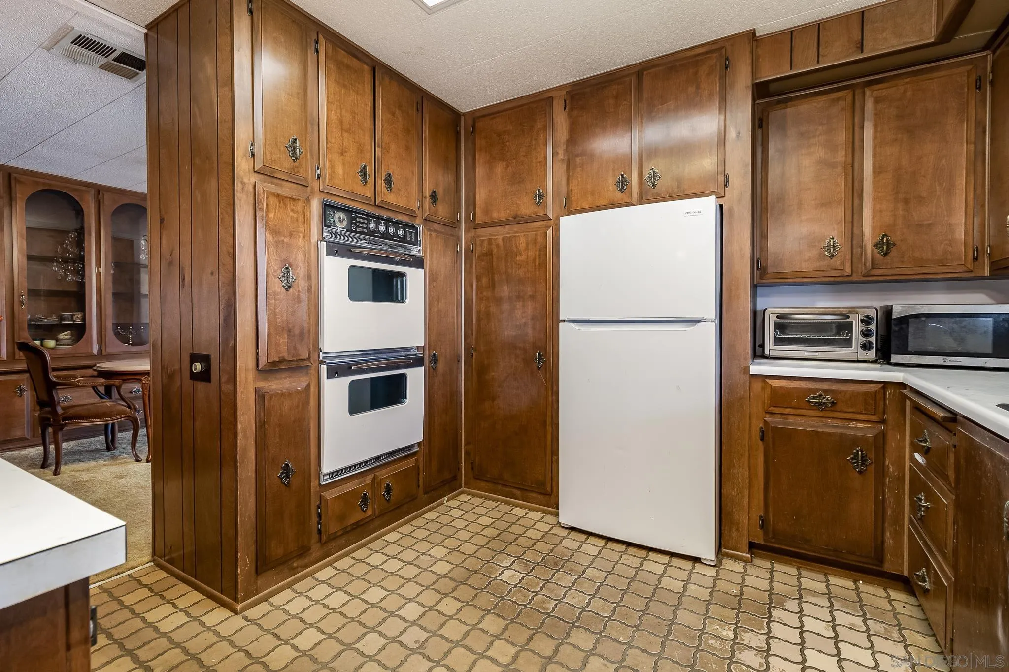 7467 Mission Gorge Road, Unit SPC 291 Santee, CA 92071 - Photo 17 of 40 a kitchen with stainless steel appliances granite countertop a refrigerator a stove and a sink with granite countertops