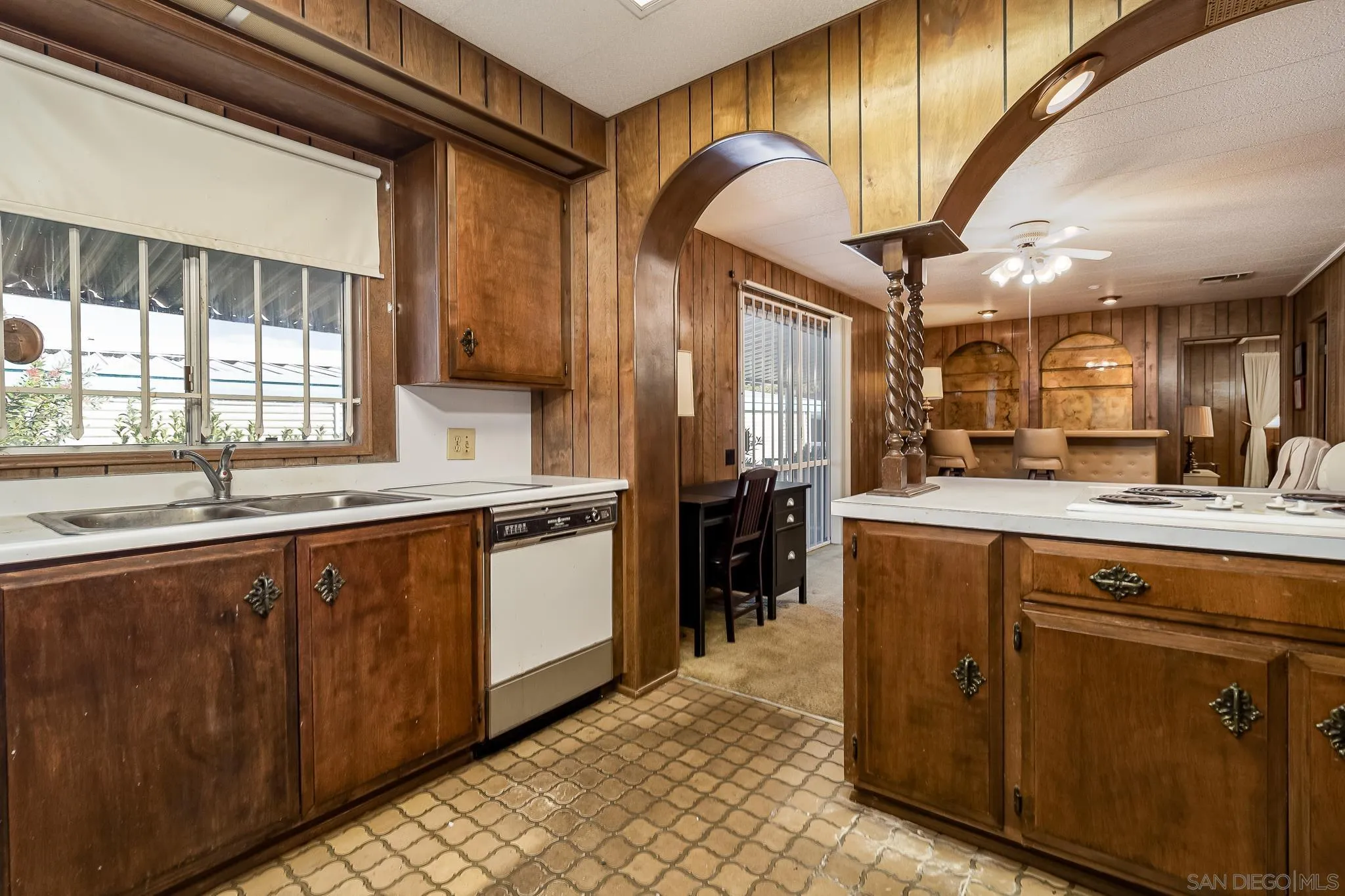 7467 Mission Gorge Road, Unit SPC 291 Santee, CA 92071 - Photo 19 of 40 a kitchen with stainless steel appliances kitchen island granite countertop a sink and cabinets