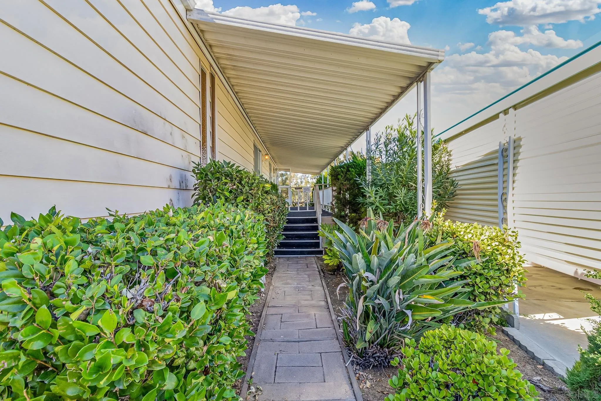 7467 Mission Gorge Road, Unit SPC 291 Santee, CA 92071 - Photo 6 of 40 a view of a pathway with plants and flowers