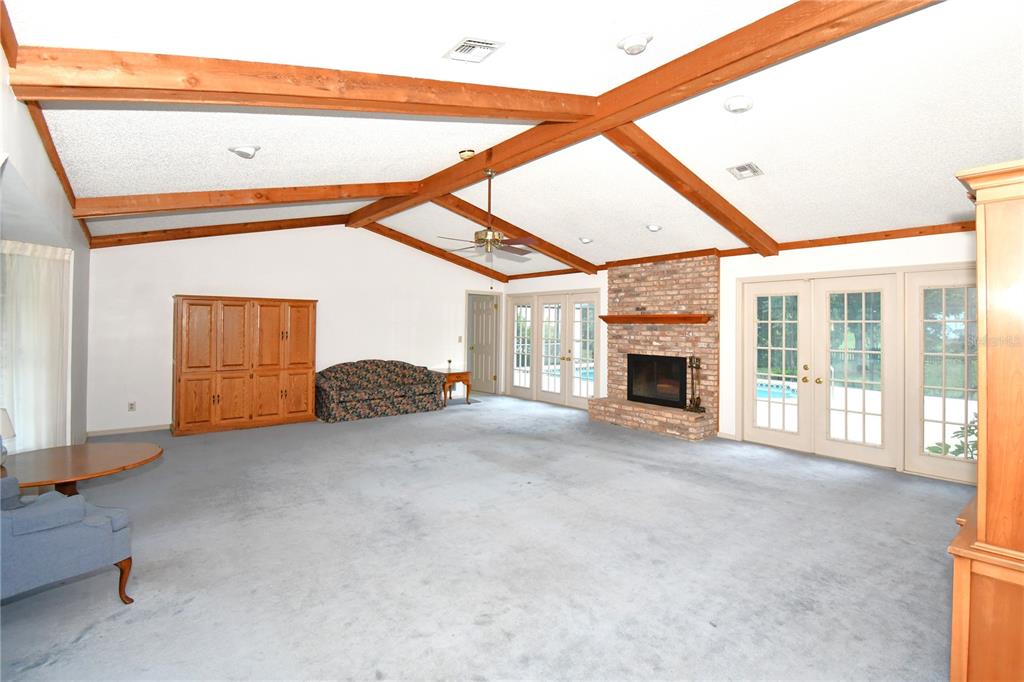 611 Old Eustis Road Mount Dora, FL 32757 - Photo 12 of 45 a view of an empty room with a fireplace and a window