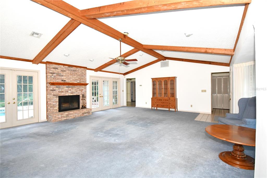 611 Old Eustis Road Mount Dora, FL 32757 - Photo 13 of 45 a view of an empty room with a fireplace and a window