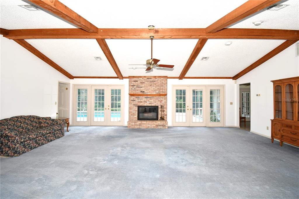 611 Old Eustis Road Mount Dora, FL 32757 - Photo 14 of 45 a view of an empty room with a fireplace and a window