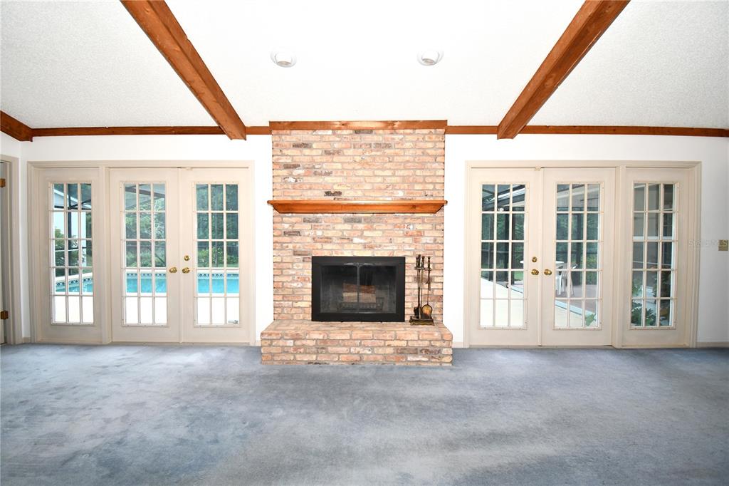 611 Old Eustis Road Mount Dora, FL 32757 - Photo 15 of 45 a view of an empty room with a fireplace and a window