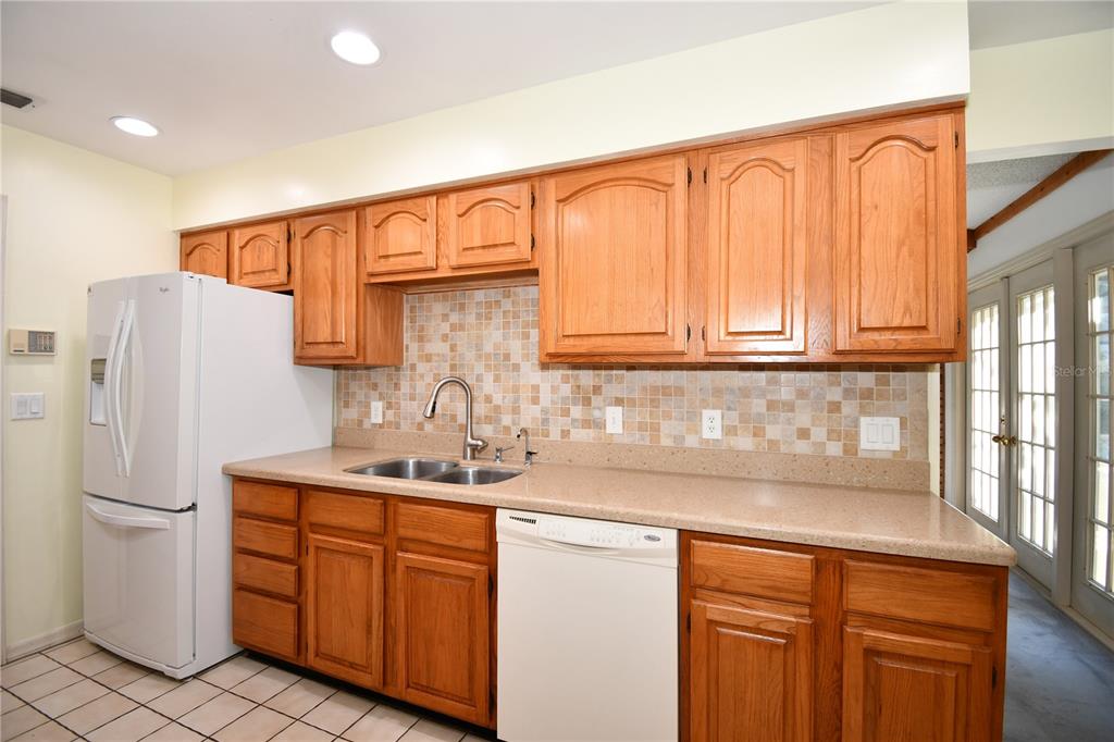 611 Old Eustis Road Mount Dora, FL 32757 - Photo 17 of 45 a kitchen with stainless steel appliances granite countertop a refrigerator sink and cabinets