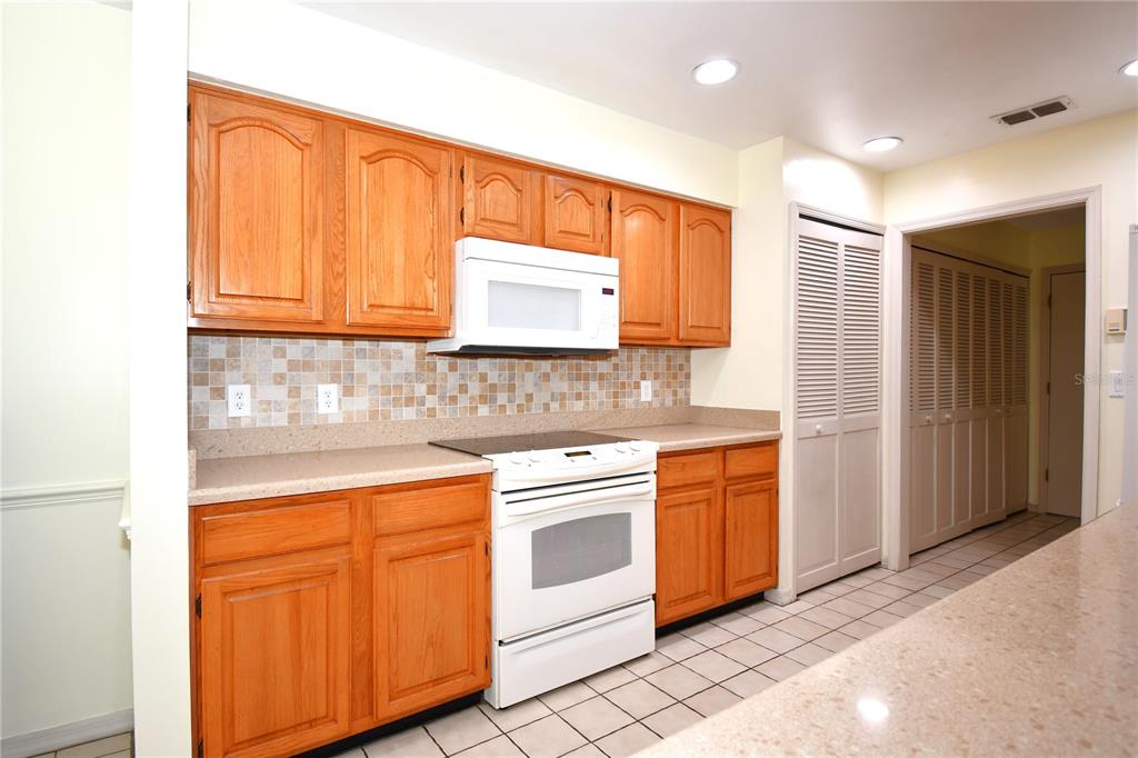 611 Old Eustis Road Mount Dora, FL 32757 - Photo 18 of 45 a kitchen with stainless steel appliances granite countertop cabinets and window