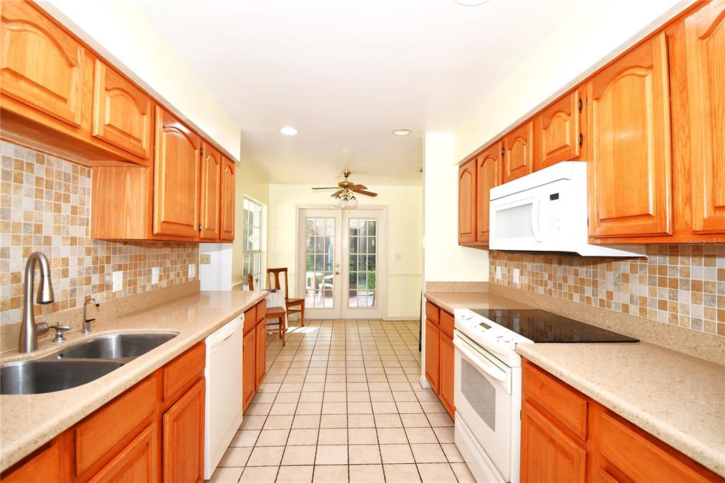 611 Old Eustis Road Mount Dora, FL 32757 - Photo 19 of 45 a large kitchen with stainless steel appliances a sink and cabinets