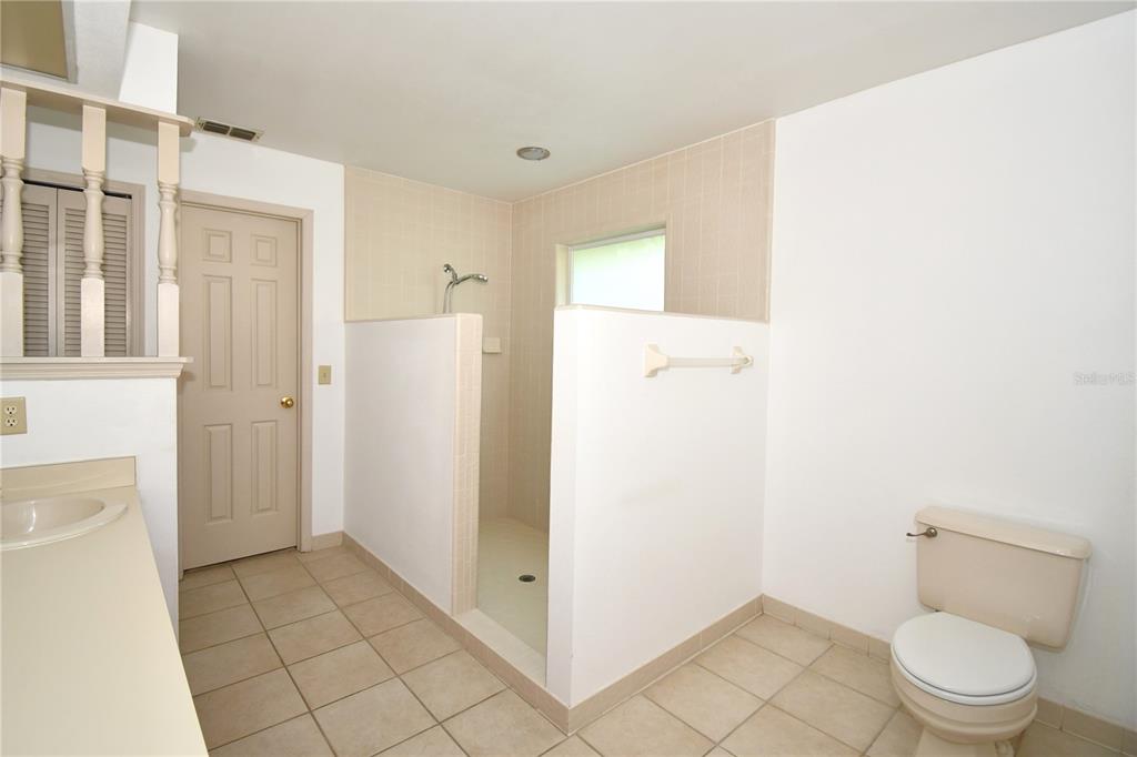 611 Old Eustis Road Mount Dora, FL 32757 - Photo 24 of 45 a bathroom with a granite countertop shower and a toilet