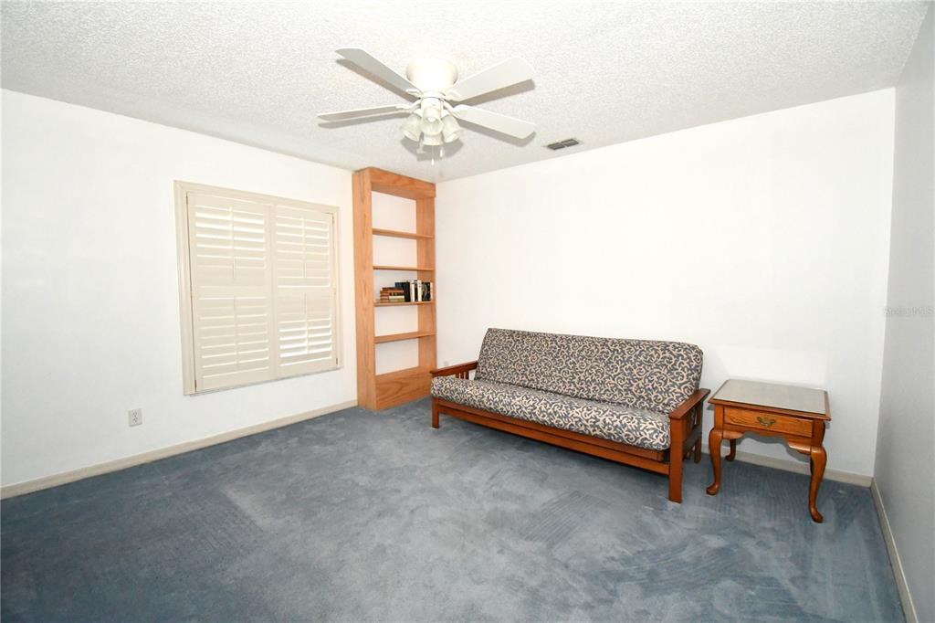 611 Old Eustis Road Mount Dora, FL 32757 - Photo 27 of 45 a bedroom with a bed and a chandelier