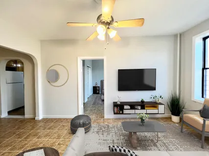 a living room with furniture and a flat screen tv