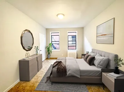 a spacious bedroom with a bed a mirror and a window