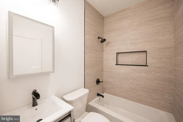 a bathroom with a bathtub and a sink