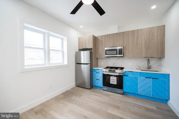 a kitchen with stainless steel appliances granite countertop a stove a sink dishwasher a refrigerator and a microwave oven