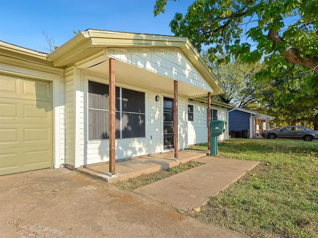 a backyard of a house with yard and outdoor seating