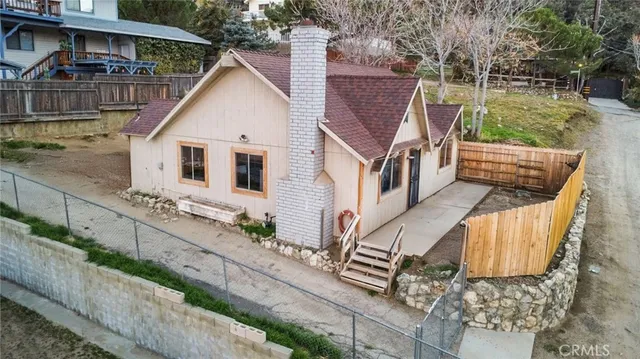 a view of a house with wooden deck and backyard
