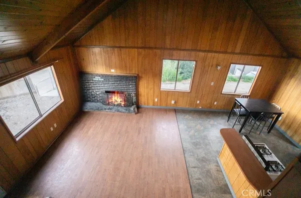 a view of a livingroom with furniture wooden floor and windows