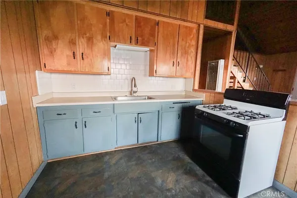 a kitchen with a sink stove and cabinets