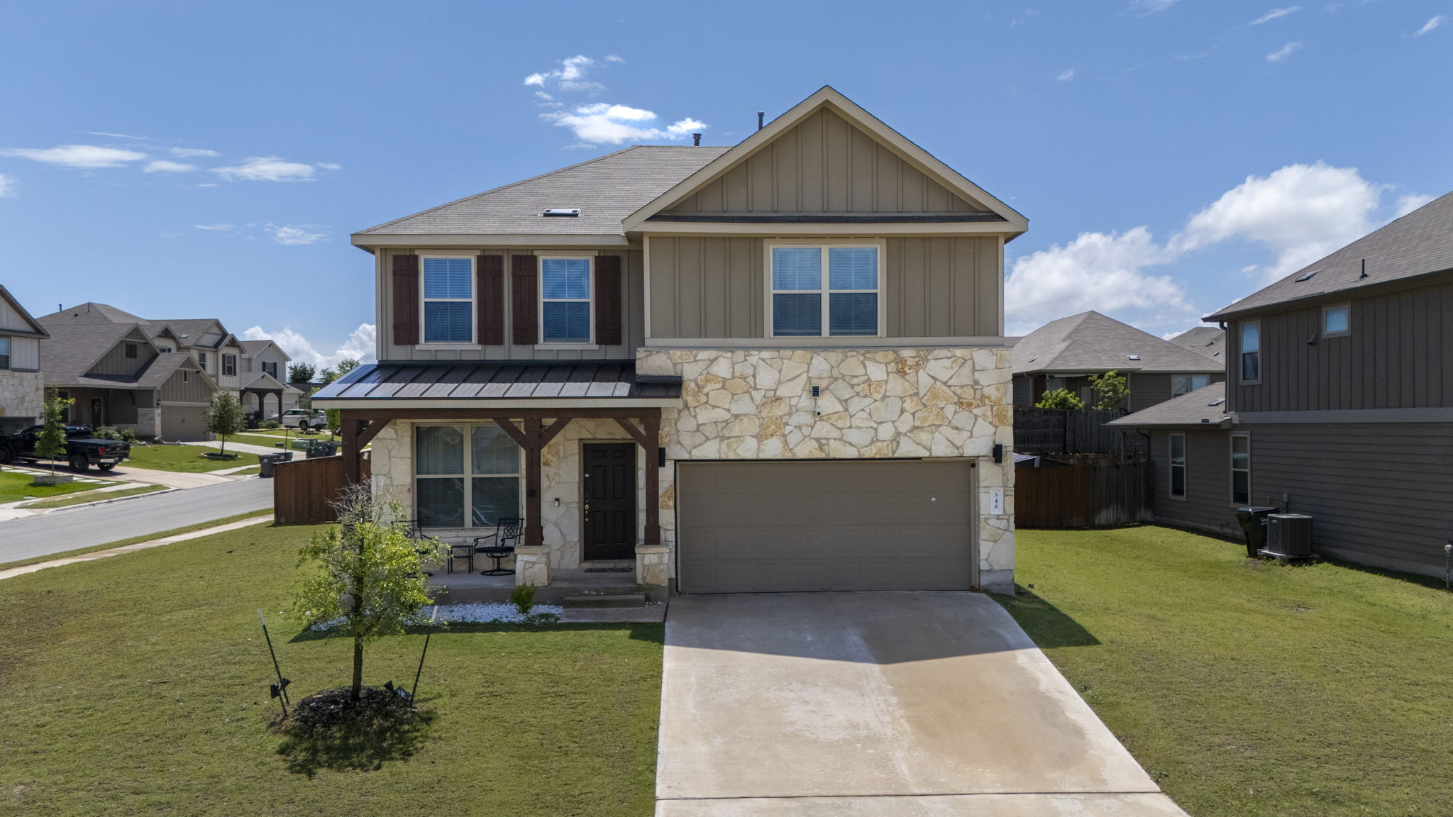 548 Purple Heart Drive Buda, TX 78610 - Photo 1 of 35 Stone and siding exterior elevate this inviting two-story residence with an attached garage.