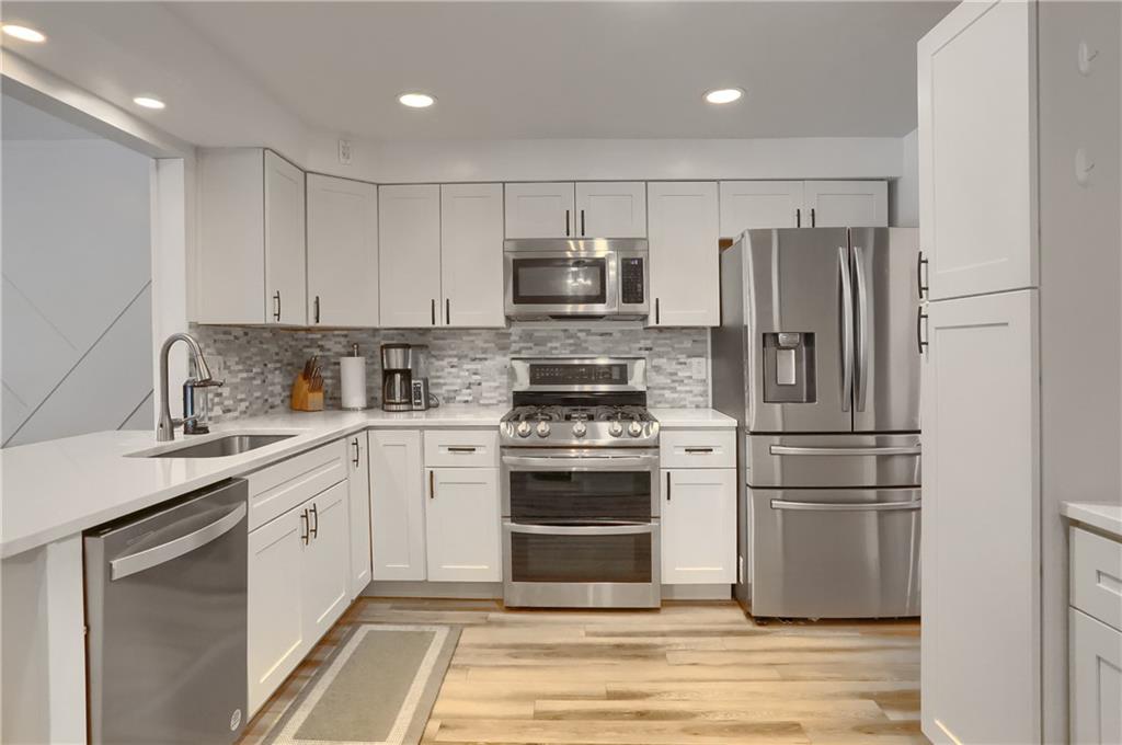 9652 Shirley Drive Allison Park, PA 15101 - Photo 14 of 49 a kitchen with a refrigerator stove and sink